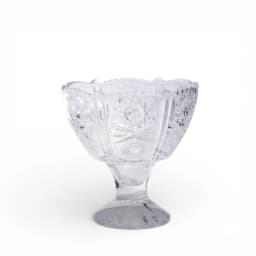 Clear glass dessert bowl with intricate cut patterns and a scalloped rim on a small pedestal, white background. - view 2