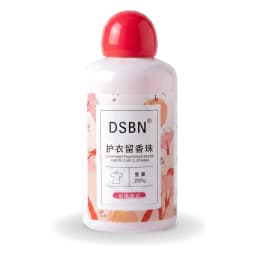 White bottle of clothing fragrance beads with a red cap and cherry jasmine label, 220g, on a wooden surface. - view 2