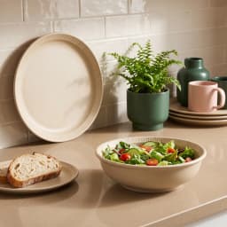 Three beige porcelain dinnerware pieces: a large dinner plate, a smaller salad plate, and a deep bowl, all with ribbed edges. - view 3