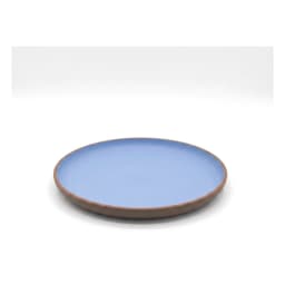 Round blue melamine plate with a brown rim, holding scrambled eggs, avocado, and cherry tomatoes. - view 2