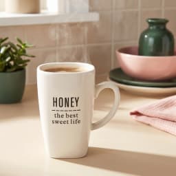Single white ceramic mug with 'Honey the best sweet life' quote in black text, on a white background. - view 1