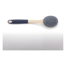 Long-handled silicone bath brush with grey bristles and a beige and dark grey handle, resting on a green soap dish with foam. - view 3