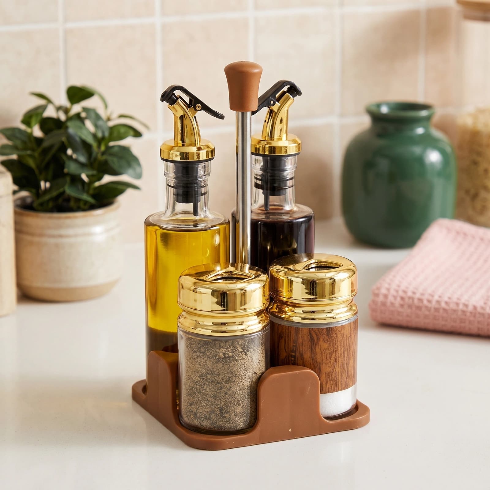 Four-piece glass cruet set with wood-grain design and gold caps on a brown plastic stand, on a white background.