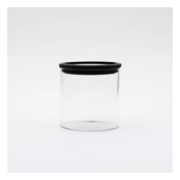 Clear cylindrical glass storage jar with a black circular lid on a white background, viewed from the front. - view 3