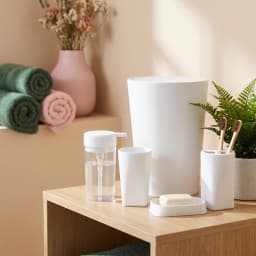 Six white plastic bathroom accessories set including a trash can, toilet brush, soap dispenser, tumbler, soap dish, and toot… - view 1