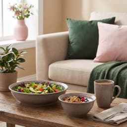 Five pieces of a grey speckled porcelain dinner set, including two plates, two bowls, and one mug, arranged on a white backg… - view 3