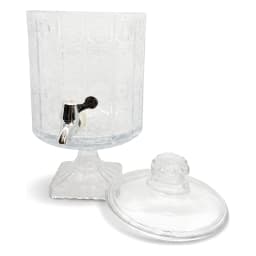 Clear glass beverage dispenser with decorative patterned body, silver spigot, and matching lid on a white background. - view 2