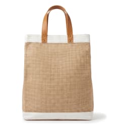 Rectangular natural brown jute tote bag with white canvas trim and light brown faux leather handles, standing on a white she… - view 2