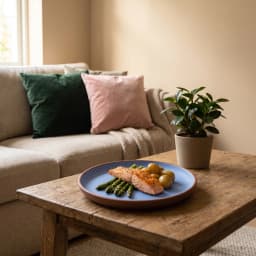 A single round blue melamine plate with a visible brown rim, resting on a plain white background. - view 4