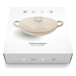 Beige cast iron braiser with a clear knob lid and two side handles, 26 cm diameter, on a white surface. - view 2