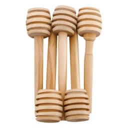Five light brown wooden honey dippers with spiral grooves, standing upright against a white background. - view 3