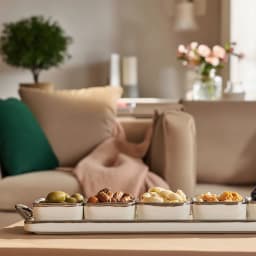 Cream porcelain serving set with five square bowls and a rectangular tray, all with silver trim, on a white background. - view 4