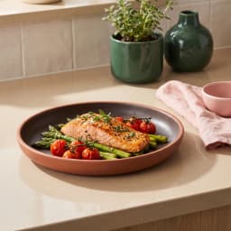Single round black and brown melamine plate with a matte finish on a white background - view 1