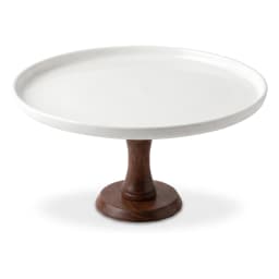 White porcelain cake stand with a dark brown wooden pedestal base on a white background, viewed from a slight angle. - view 2
