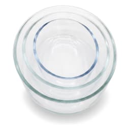 Three clear oval glass baking dishes, stacked from largest to smallest, on a white background. - view 4