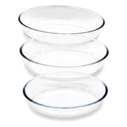 Three clear oval glass baking dishes, stacked from largest to smallest, on a white background. - view 3