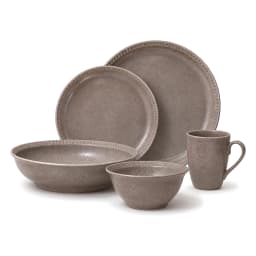 Five pieces of a grey speckled porcelain dinner set, including two plates, two bowls, and one mug, arranged on a white backg… - view 2